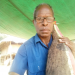 Me with a 80 cm 8kg yam tuber presented to me in a Yam cultu