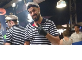 Guy cooking calamari in the outside food court in Vienna.